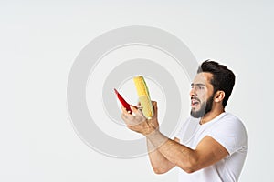 bearded man in white t-shirt holding vegetables, dislikes peppers and corn