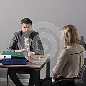 Bearded man and woman have business meeting. Businessman and businesswoman sit at office desk. Concentration at work