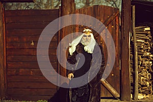 Bearded man on wooden background in golden crown