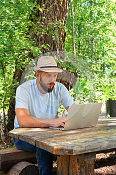 Bearded man working freelance. A freelance computer programmer. Freelance professional work off site on laptop computer
