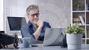 Man working with laptop at home office photo