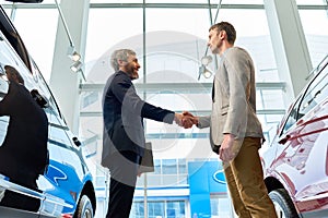 Bearded Manager Selling Cars in Showroom