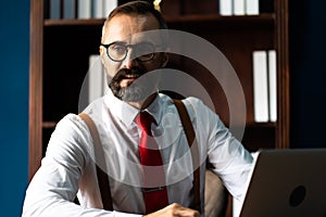 Bearded middle-aged Business man wearing suit online working at home. Work at home and stay at home. Social distancing