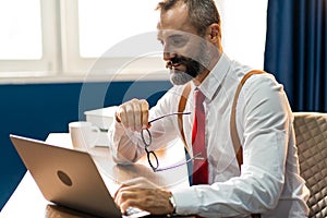 Bearded middle-aged Business man wearing suit online working at home. Work at home and stay at home. Social distancing