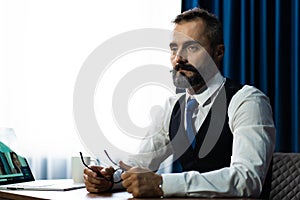 Bearded middle-aged Business man wearing suit online working at home. Work at home and stay at home. Social distancing