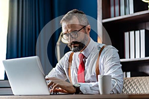 Bearded middle-aged Business man wearing suit online working at home. Work at home and stay at home. Social distancing