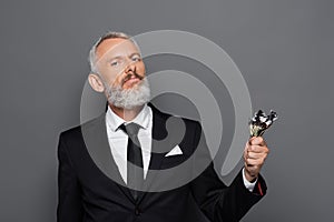 bearded middle aged businessman holding burning