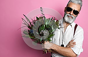 Bearded middle-aged man with flowers.