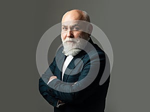 Bearded middle-aged man with a serious expression in a closeup head and shoulders portrait. Serious Senior Man. Waist up