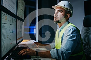 Bearded operator of factory control industry process using monitors