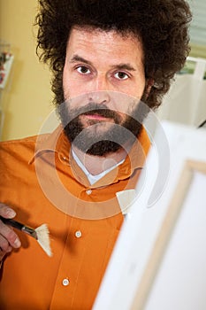 Bearded painter in his studio