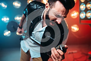 Bearded performer with microphone sing a song