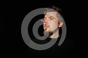 Bearded prankster with clothespin on nose. Funny joke concept photo