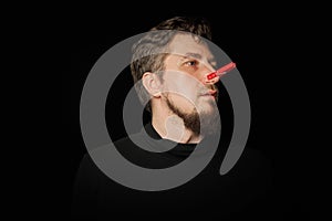 Bearded prankster with clothespin on nose. Funny joke concept photo