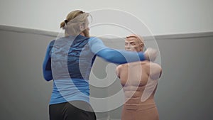 Bearded professional man with athletic body and blond long hair make sidekick to a bob box mannequin in the gym