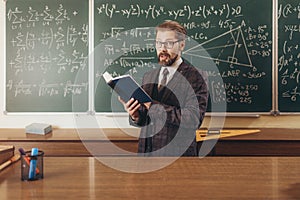 Bearded Professor in Suit and Glasses Citing a Manual