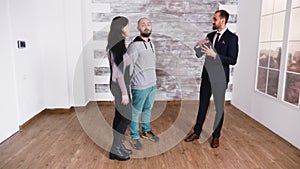 Bearded real estate agent in business suit showing new apartment