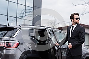 bearded safeguard in suit and sunglasses