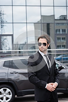 bearded safeguard in suit and sunglasses