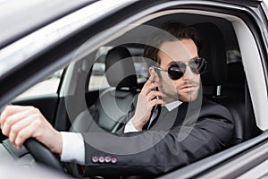 bearded safeguard in sunglasses and suit