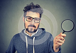 Curious man investigating with magnifier photo