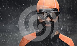 Bearded scuba swimmer under rain drops.