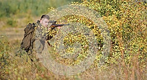 Bearded serious hunter spend leisure hunting. Hunter hold rifle. Man wear camouflage clothes nature background. Hunting