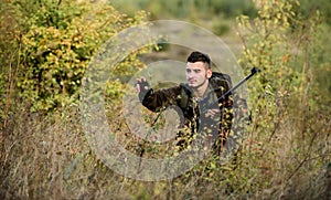 Bearded serious hunter spend leisure hunting. Man wear camouflage clothes nature background. Hunting permit. Hunter hold