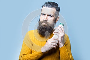 Bearded serious man with milk bottle