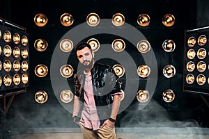 Bearded singer on stage with decorations of lights