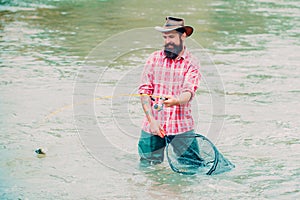 Bearded son. Fishing on the lake. Man enjoy peaceful idyllic landscape while fishing. Man in shirts fishing at morning