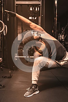 A bearded sporty man in the gym is doing Yoga and Martial Arts exercises. Fierce Warrior Pose Yoga Sequence.