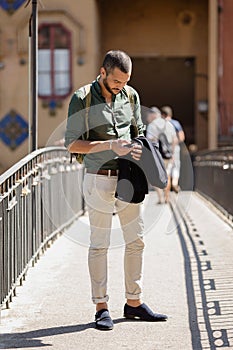 Bearded traveller chatting over his phone