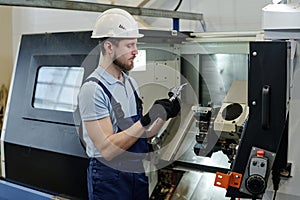 Bearded Turner At Work In Factory