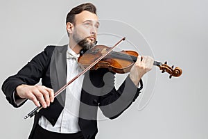 Bearded violinist playing classical music at concert