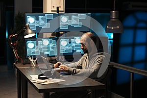 Caucasian male programmer writing code and debugging software