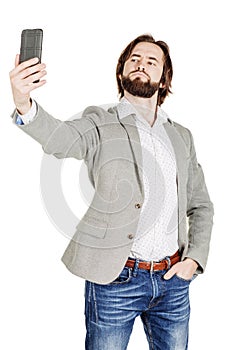 bearded young business man taking selfie smiling. portrait isolated over white studio background.