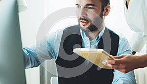 Bearded young businessman working at office. Director man thinking looking in monitor computer. Managers meeting