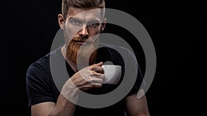 Bearded young man drinking espresso