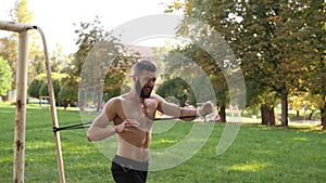 Bearded young muscular athlete doing workout exercises near a football goal. 4K slow mo footage