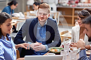 Beardy caucasian with his friends at lunch in restaurant. friends, colleagues, business partners, lunch, break