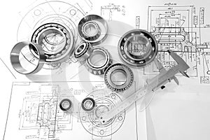 Bearings and drawings under a desk lamp