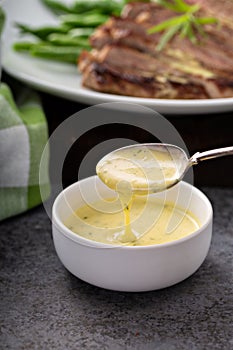 Bearnaise sauce in a small bowl photo
