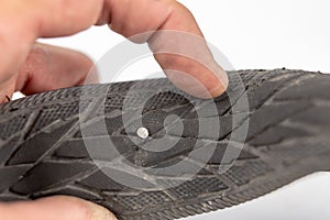 A beaten bicycle tire in the workshop. A bicycle wheel pierced w