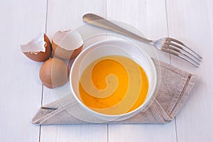 Beaten egg yolks in a bowl with fork