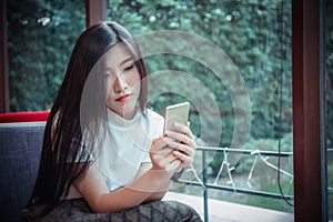 Beatiful asian girl`s holding mobile and have emotion happy looking at mobile phone