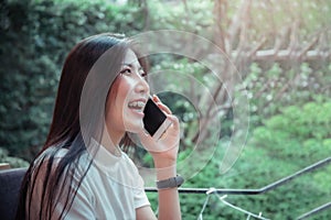 Beatiful asian girl`s holding mobile and have emotion happy looking at mobile phone