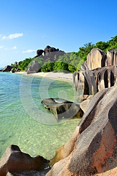 Beatiful beach Anse Source d`Argent with big granite rocks in sunny day. La Digue Island, Seychelles.