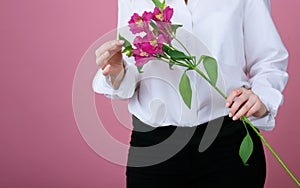 Beatiful girl with a beatiful flowers on a pink background