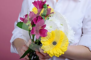 Beatiful girl with a beatiful flowers on a pink background